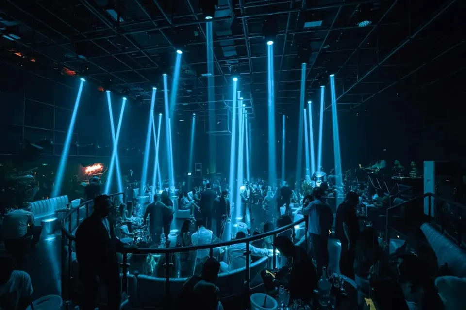 Main room dance floor with blue vertical beam lights and VIP seating at Ora Club Dubai Night club